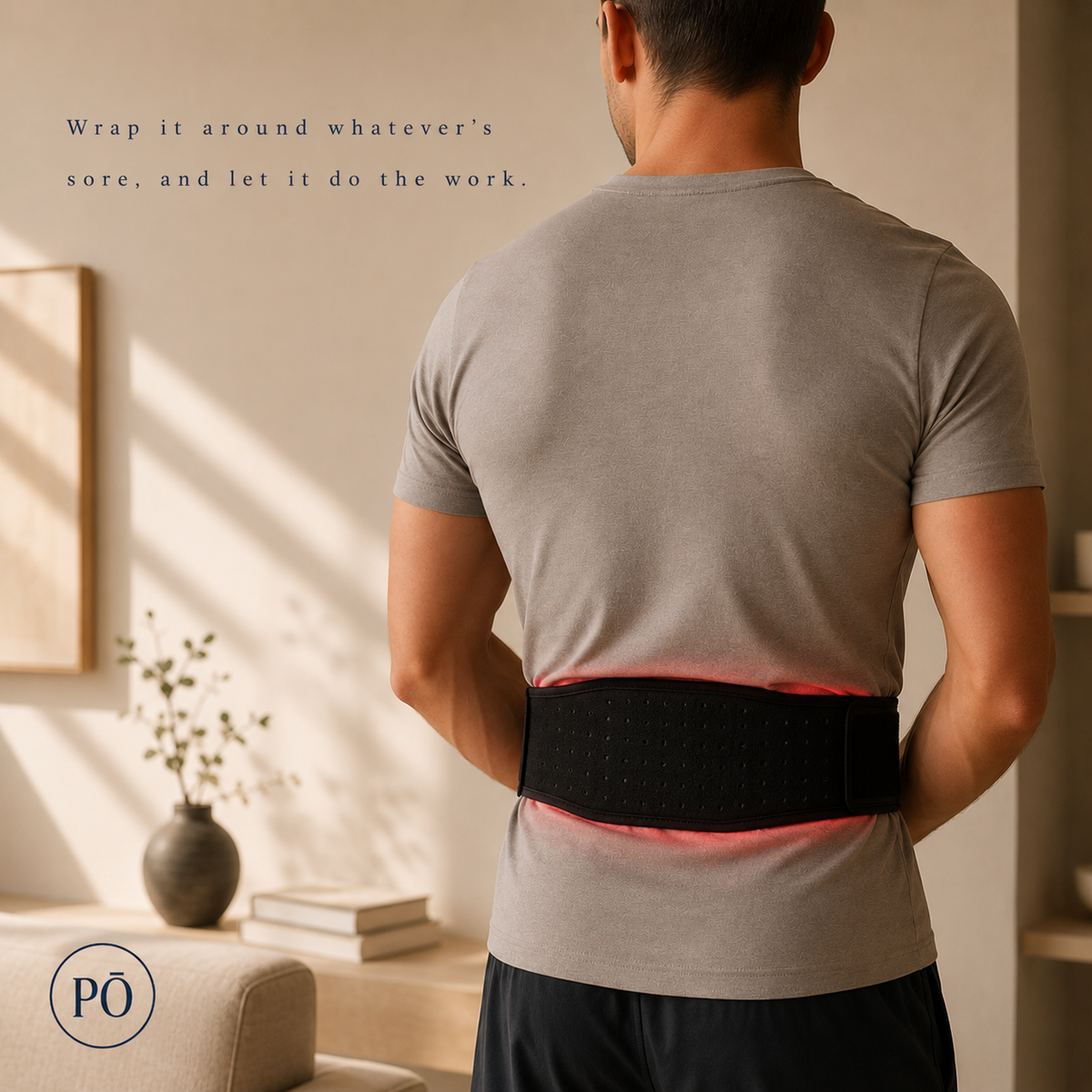 Man wearing the PHŌRMA Flex Light therapy belt wrapped around his lower back, red light glowing at the edges
